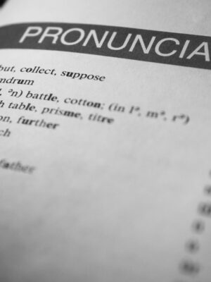 Black and white close-up of a dictionary page focused on pronunciation guides and phonetic symbols.