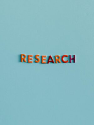 Colorful uppercase letters spelling 'RESEARCH' on a soft blue background. Ideal for education and science topics.