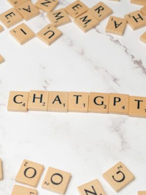 Wooden letter tiles spelling 'ChatGPT' on a marble surface, creating a tech concept image.