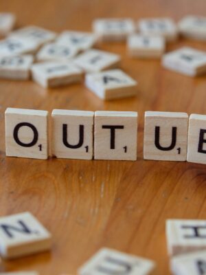 Wooden letter tiles spelling 'YOUTUBE' on a wooden surface, symbolizing video sharing and streaming.